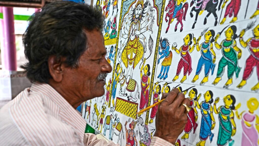 Chitrakar Laxmidhar Mohapatra while working on his signature style Osakothi Painting at his studio at Digapahandi.